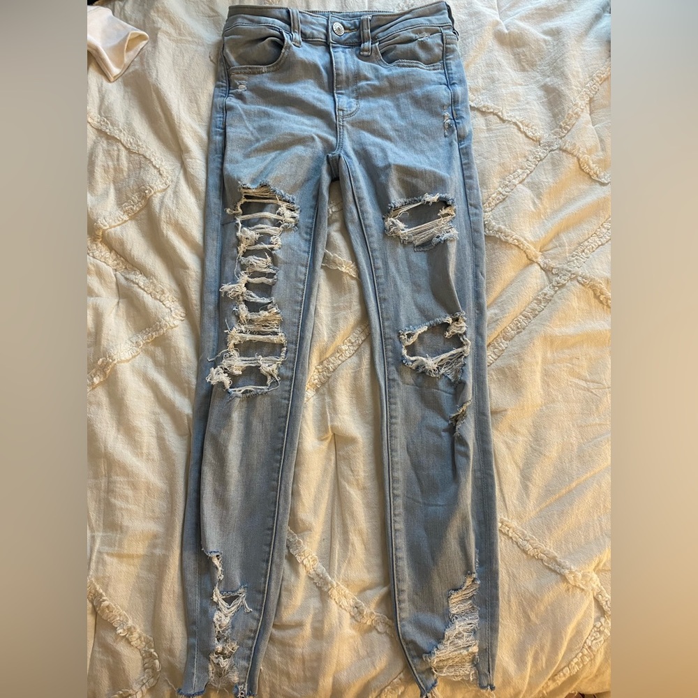 American Eagle light wash jeans with rips on legs and bottoms